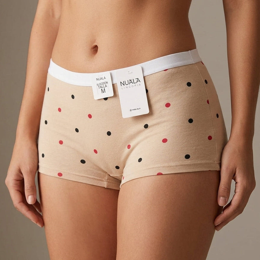 A model wearing beige Nurla cotton briefs with a black and red polka-dot pattern and a white waistband, shown from the waist down against a neutral studio background.