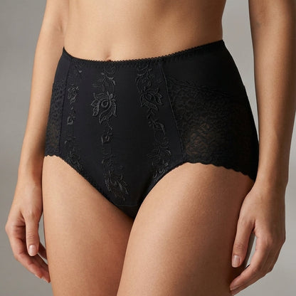 Black high-waisted lace underwear with tonal floral embroidery, shown on a model against a neutral gray background.